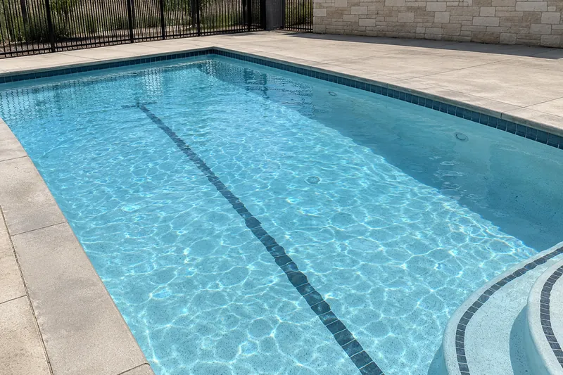 Full community pool with a white quartz finish and a dark lane line