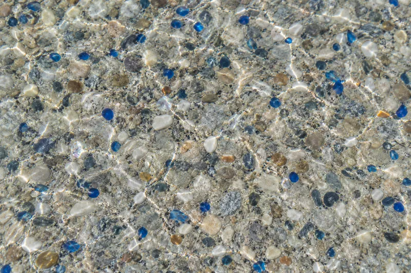 Pebble pool finish with blue glass beads and shell flecks