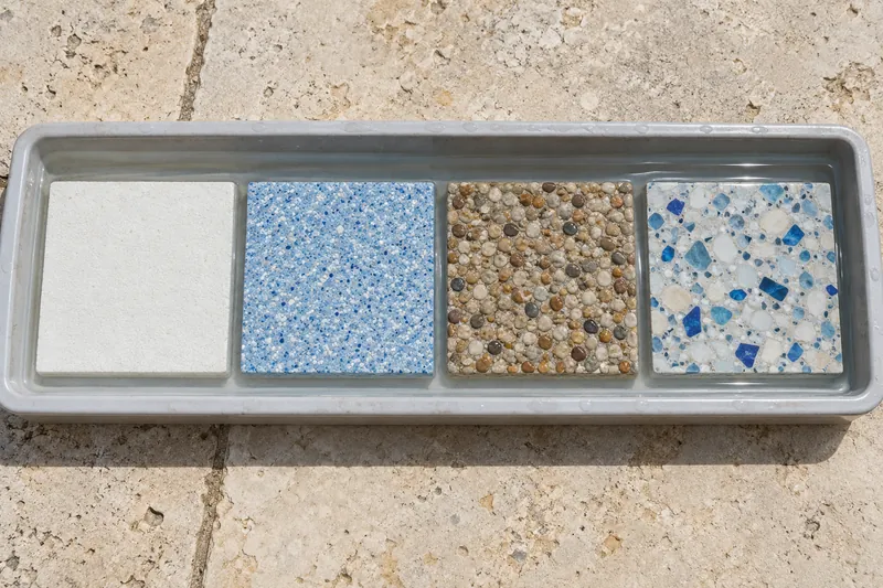Plaster, quartz, pebble and polished finish samples side by side under water